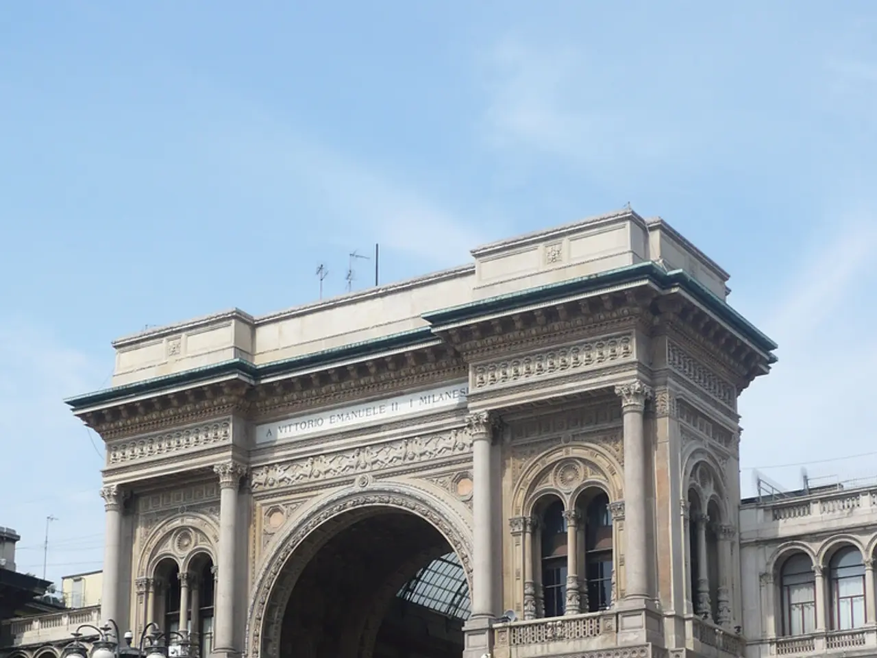 In the picture we can see a gateway of the palace with a art and pillars to it and near it we can...