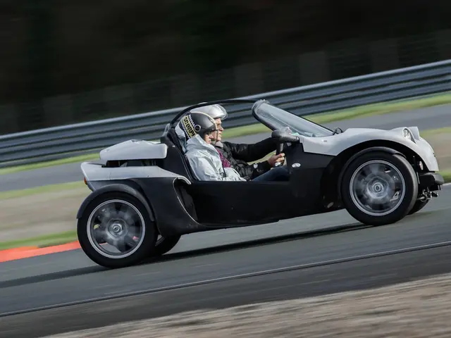 This picture is clicked outside. In the center we can see a person sitting in the vehicle and...