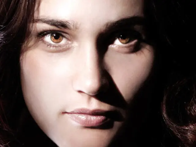 This is a magazine. In this magazine we can see a woman. At the bottom of the image, there are...